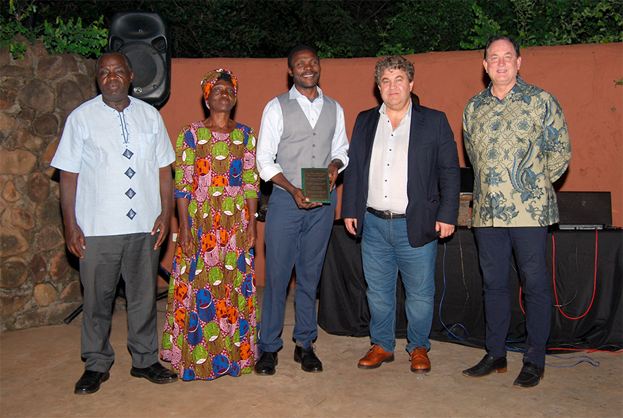 Michael Olabisi and team with award and directors of the legume lab